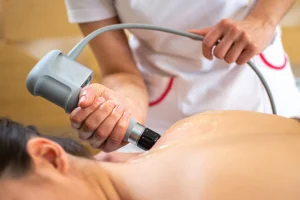 a patient is receiving targeted shockwave therapy on their shoulder